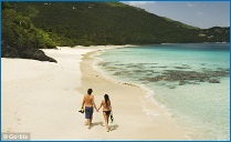 Picture of a couple relaxing on a deserted beach on a tropical island